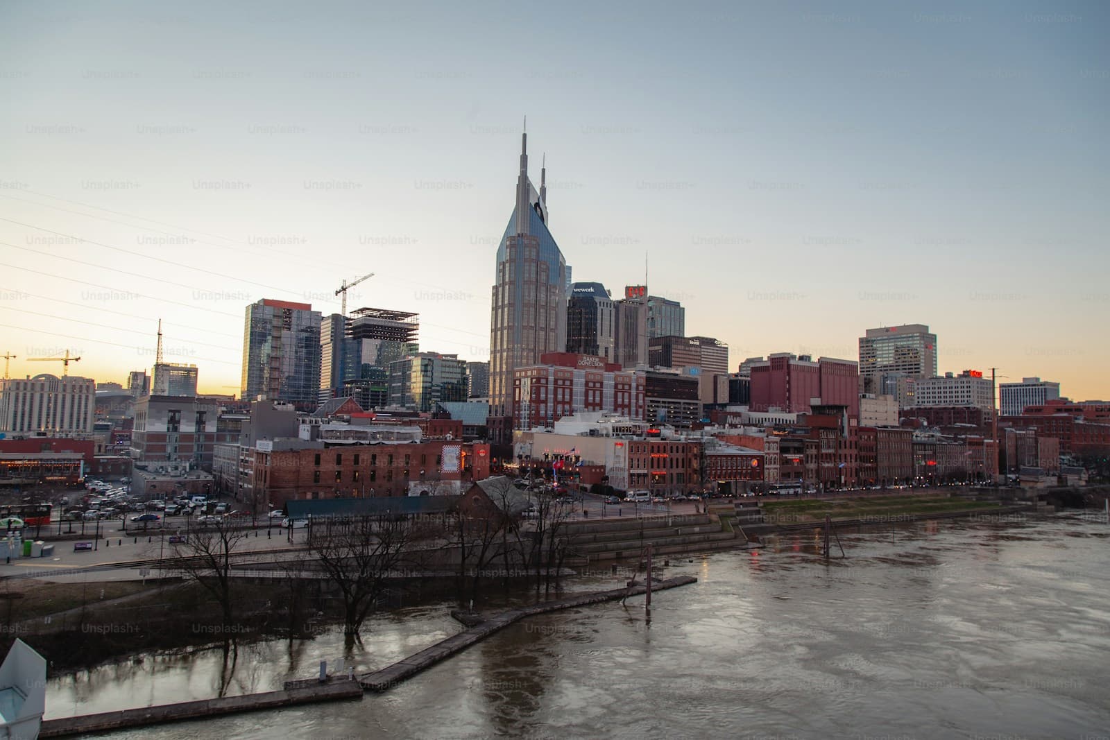 Nashville skyline at sunset with AT&T Building and Cumberland River in foreground